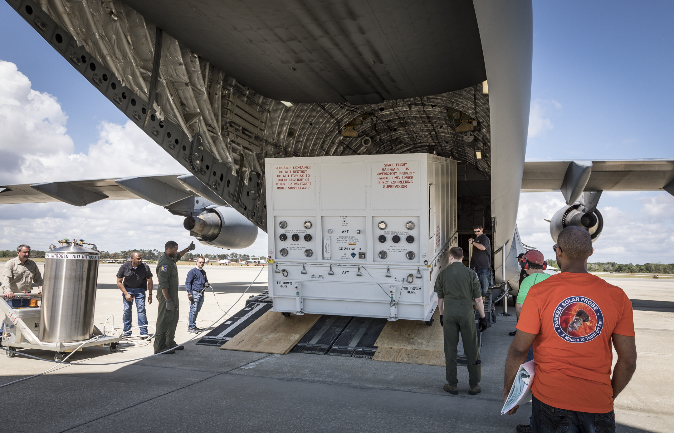 Securely packed in its custom transport container, NASA’s Parker Solar Probe is unloaded from the C-17 of the United States Air Force’s 436th Airlift Wing after landing at Space Coast Regional Airport in Titusville, Florida, on the morning of April 3, 2018. After unloading, the spacecraft was taken to Astrotech Space Operations, also in Titusville, for pre-launch testing and preparations. 