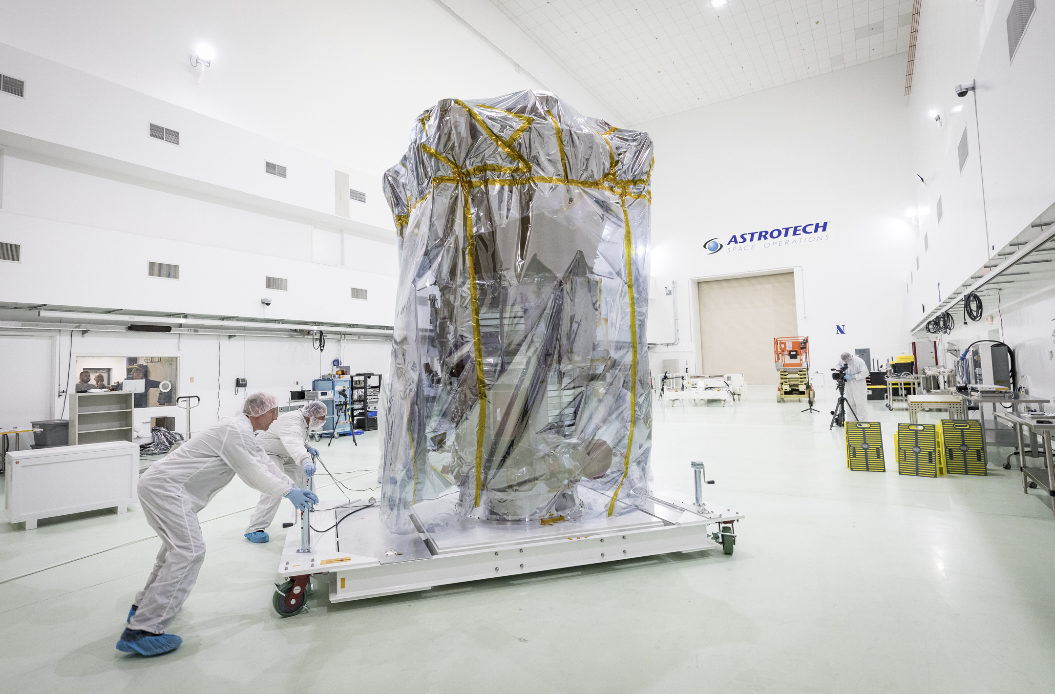 NASA’s Parker Solar Probe is wheeled into position in a clean room at Astrotech Space Operations in Titusville, Florida, for pre-launch testing and preparations. On April 3, 2018, the spacecraft was transported from NASA’s Goddard Space Flight Center in Greenbelt, Maryland, to Joint Base Andrews by truck, then by a United States Air Force C-17 to Titusville. 