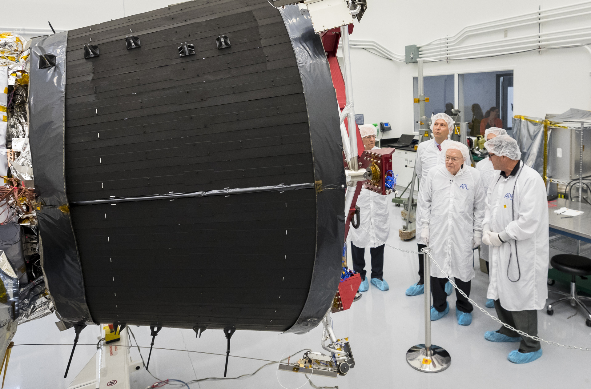 Eugene Parker, professor emeritus at the University of Chicago, visits the spacecraft that bears his name, NASA’s Parker Solar Probe, at the Johns Hopkins Applied Physics Laboratory in Laurel, Maryland, where the probe was designed and is being built. The large black structure is one of the spacecraft's massive cooling radiators. The spacecraft is humanity’s first mission to a star – it will travel directly through the Sun’s atmosphere.  