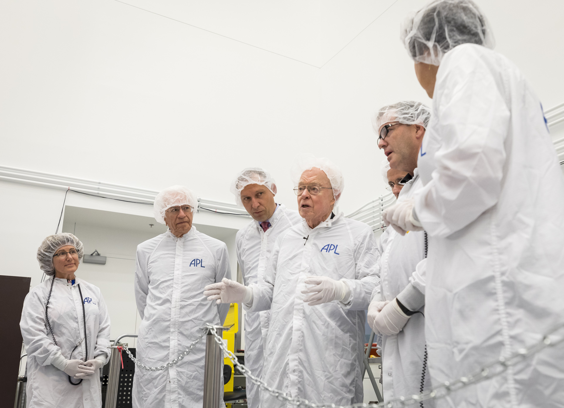 Members of the Parker Solar Probe team and NASA and APL leadership listen to the mission's namesake, Eugene N. Parker, center, on Oct. 3, 2017 in the spacecraft clean room at Johns Hopkins Applied Physics Laboratory.