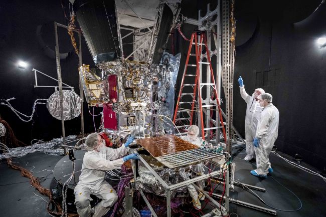 Members of the Parker Solar Probe team prepare the spacecraft for space environment testing in the thermal vacuum chamber at NASA’s Goddard Space Flight Center. The thermal vacuum chamber duplicates the airless environment of space and simulates the cold and hot temperature cycles the spacecraft will endure during its seven-year exploration of the Sun. 
