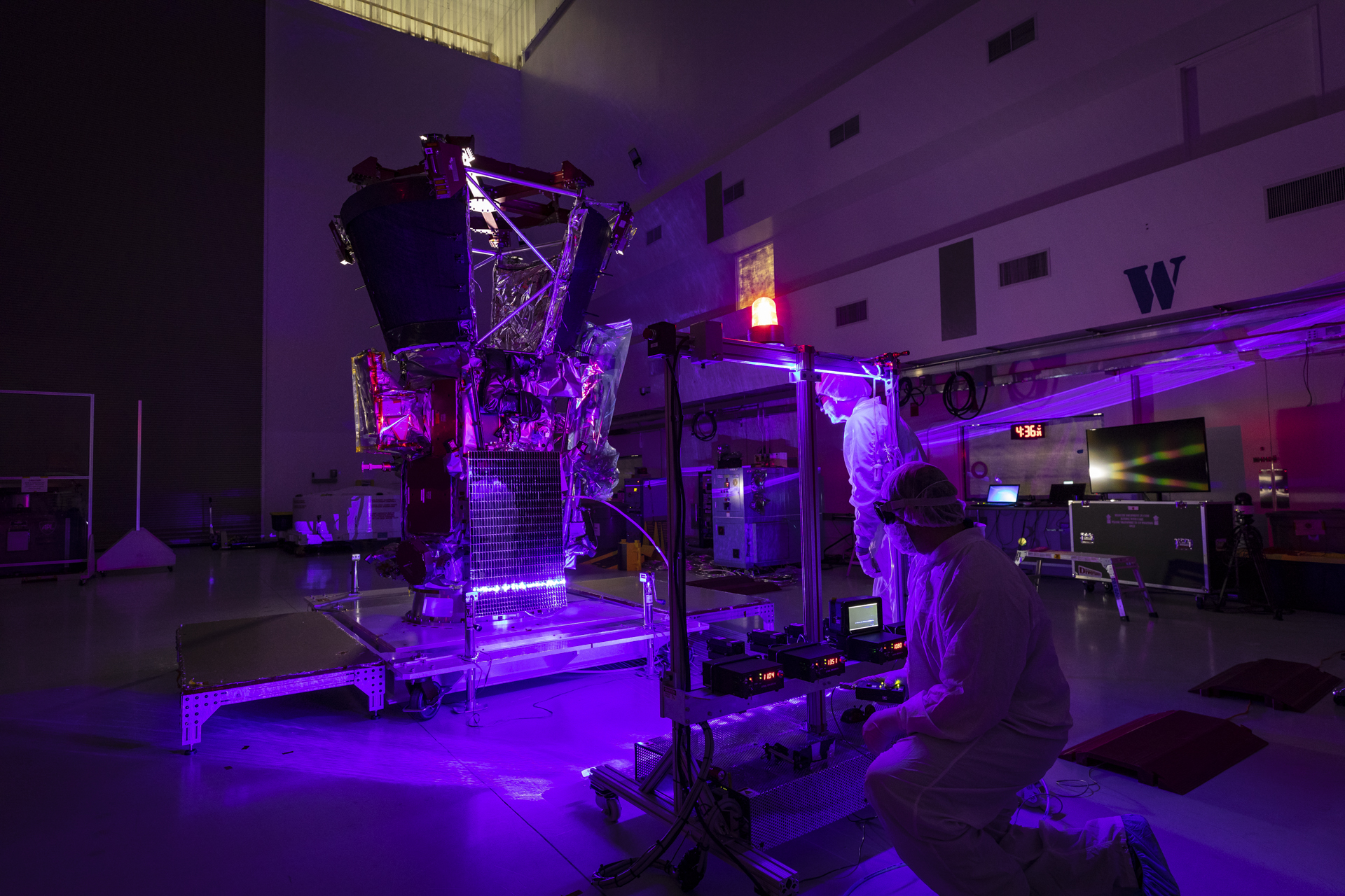 After installation of the solar arrays on May 31, 2018, Parker Solar Probe team members use a laser to illuminate the solar cells and verify that they can create electricity and transfer it to the spacecraft.