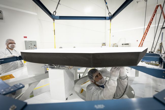 Parker Solar Probe’s heat shield is made of two panels of superheated carbon-carbon composite sandwiching a lightweight 4.5-inch-thick carbon foam core. To reflect as much of the Sun’s energy away from the spacecraft as possible, the Sun-facing side of the heat shield is also sprayed with a specially formulated white coating.