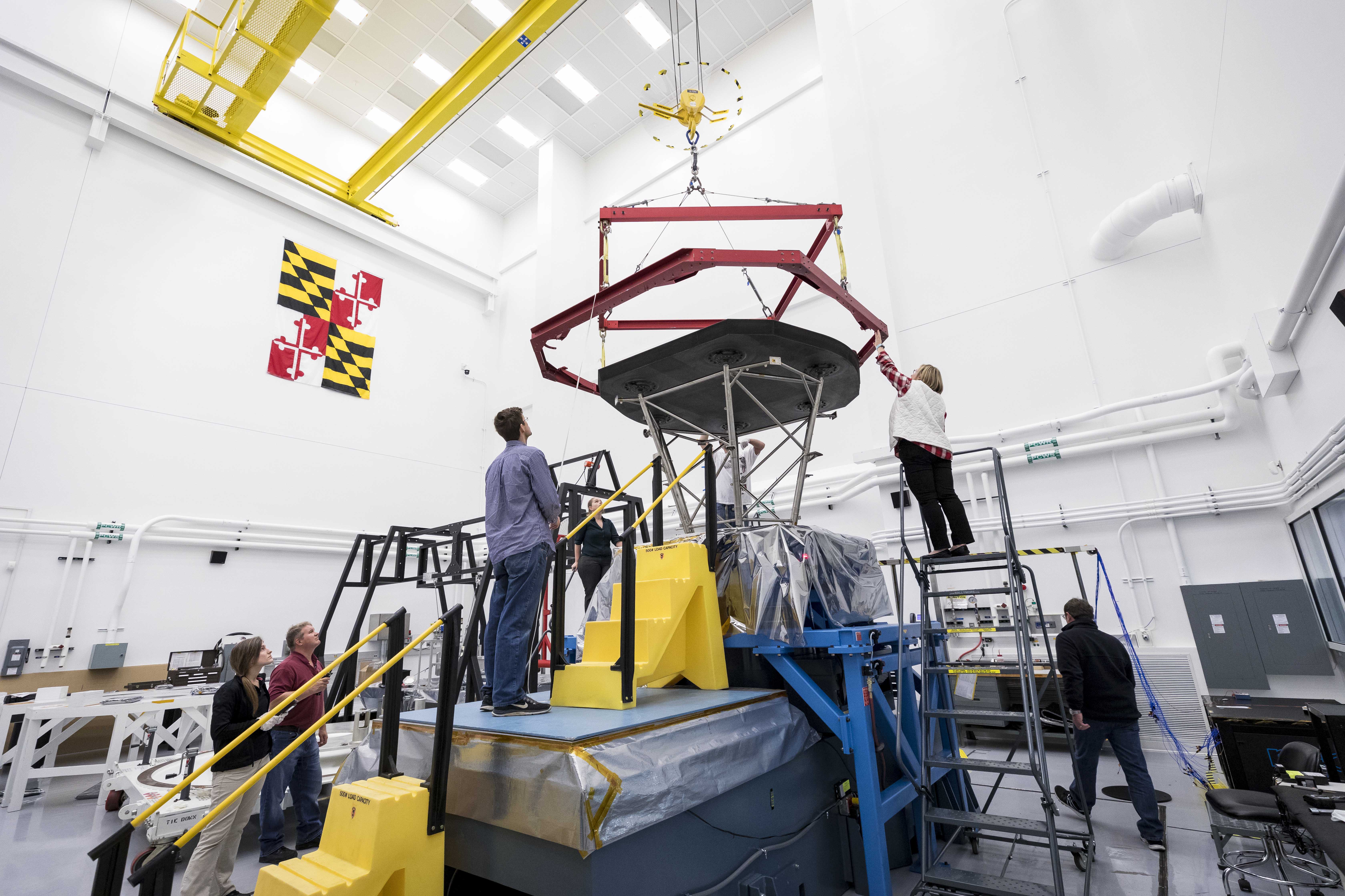 The Parker Solar Probe team at Johns Hopkins APL prepares to lift the heat shield, called the Thermal Protection System (TPS), in preparation for shipment to NASA's Goddard Space Flight Center for further environmental testing.