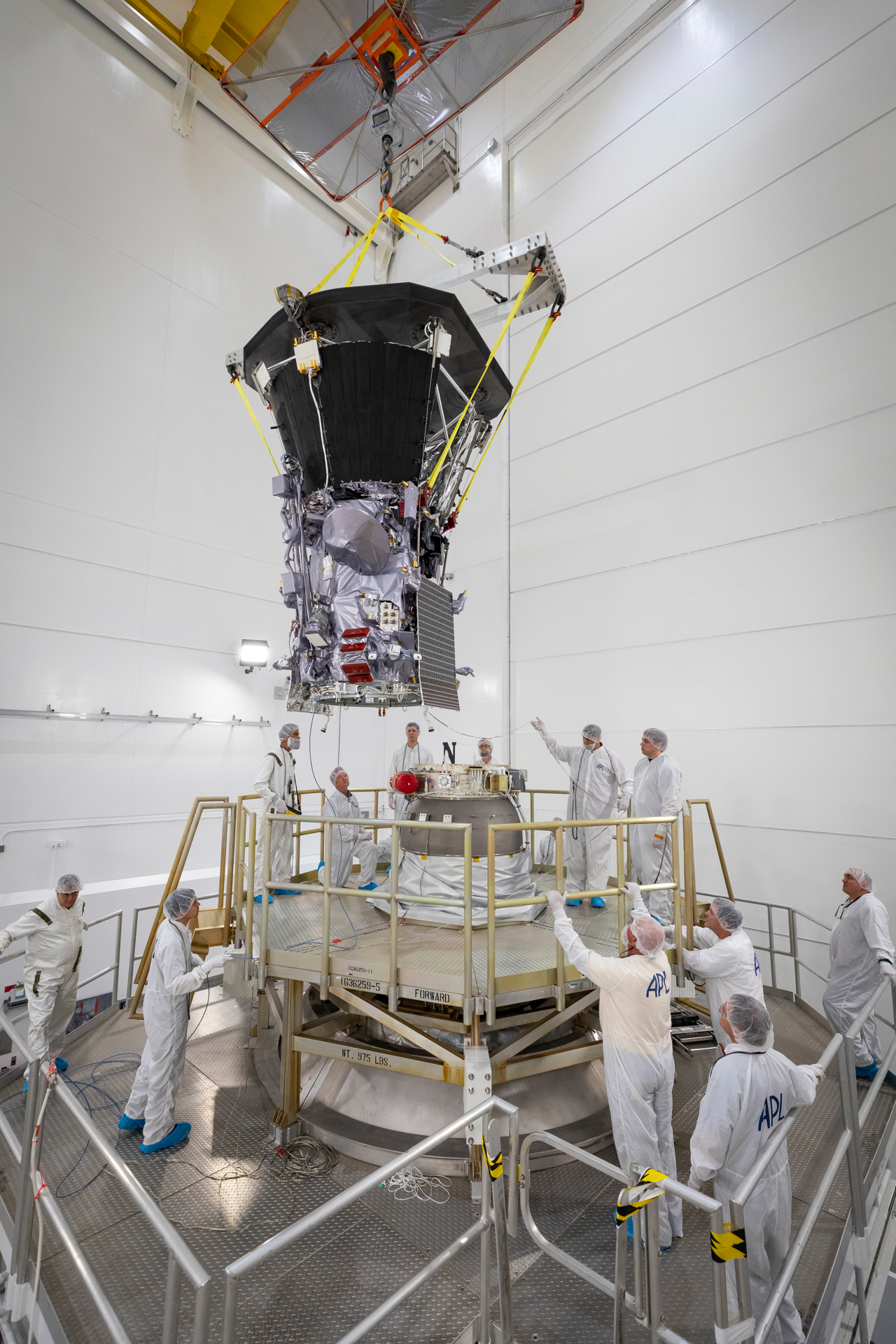 Parker Solar Probe is lowered toward the third stage rocket motor on July 11, 2018, at Astrotech Space Operations in Titusville, Florida. In addition to using the largest operational launch vehicle, the Delta IV Heavy, Parker Solar Probe will use a third stage rocket to gain the speed needed to reach the Sun, which takes 55 times more energy than reaching Mars. 