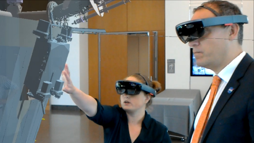 Johns Hopkins APL's Betsy Congdon (left) and NASA's Thomas Zurbuchen, head of the agency's Science Mission Directorate, at the Parker Solar Probe renaming event at the University of Chicago in May. The augmented reality spacecraft model is visible at left.