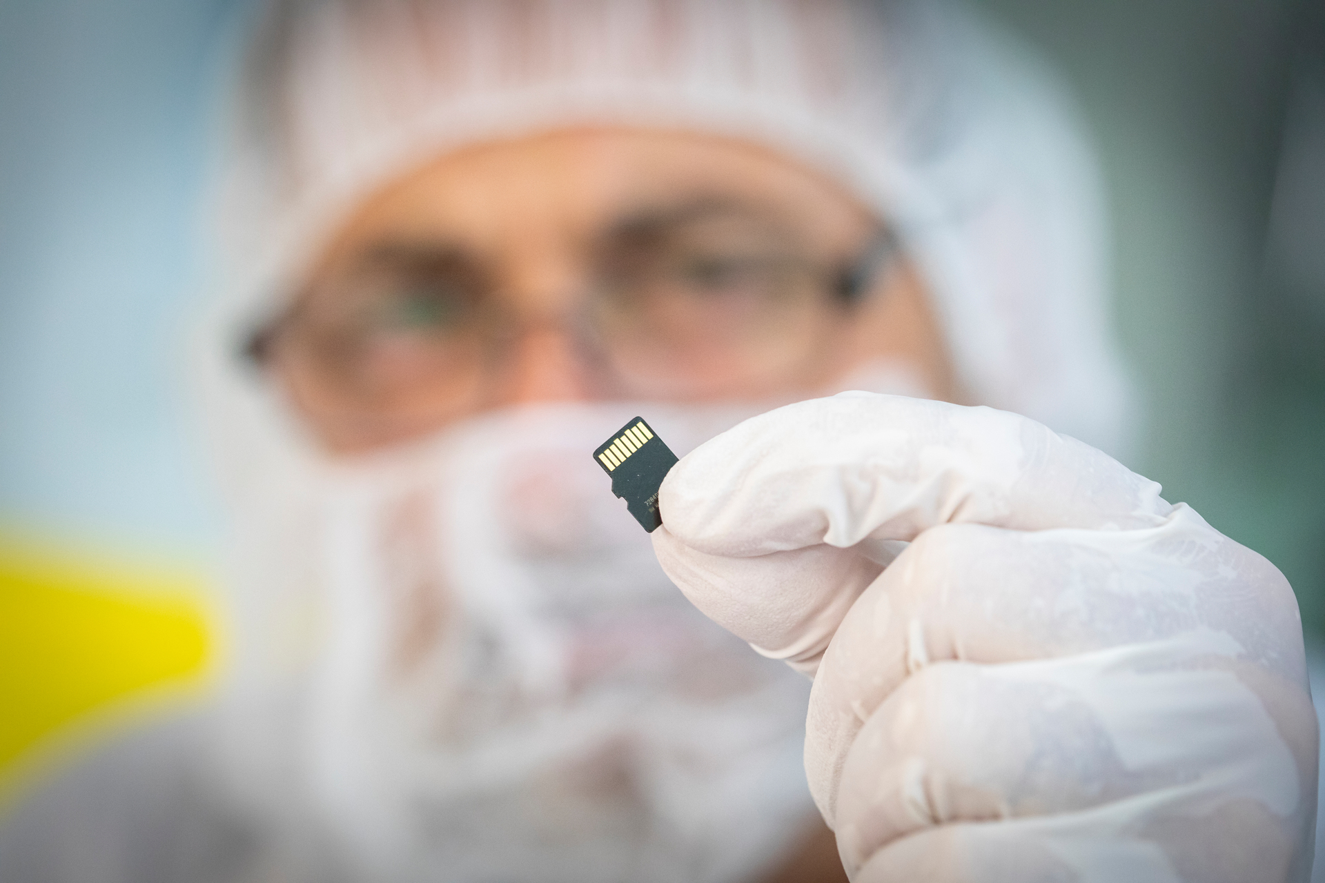 A Parker Solar Probe team member from the Johns Hopkins Applied Physics Laboratory holds the memory card containing 1,137,202 names submitted by the public to travel to the Sun aboard the spacecraft. The card was installed on a plaque which was placed on the spacecraft on May 18, 2018, at Astrotech Space Operations in Titusville, Florida. The plaque dedicated the mission to Eugene Parker, who first theorized the existence of the solar wind. Parker Solar Probe is the first NASA mission to be named for a living person.