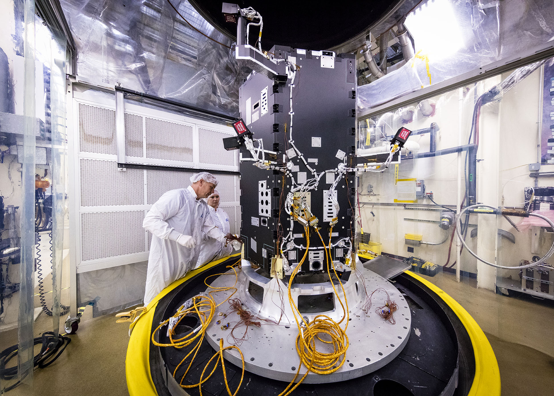 Engineers at the Johns Hopkins University Applied Physics Laboratory in Laurel, Maryland, prepare the developing Solar Probe Plus spacecraft for thermal vacuum tests that simulate conditions in space. Today the spacecraft includes the primary structure and its propulsion system; still to be installed over the next several months are critical systems such as power, communications and thermal protection, as well as science instruments.