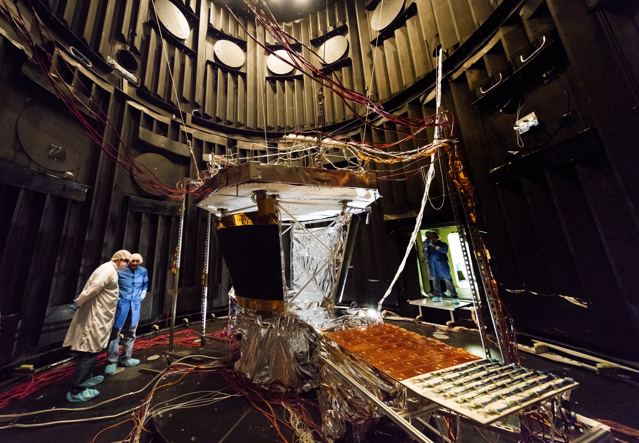 The solar array cooling system for the Parker Solar Probe spacecraft—one element of which is the large, square black radiator visible at center, one of two that will be installed—is shown undergoing thermal testing at NASA Goddard Space Flight Center in Greenbelt, Maryland in late February. At left: William “Chip” Delmar and C. Jack Ercol of the Johns Hopkins Applied Physics Laboratory; on right, Mike Micciolo of NASA Goddard and APL’s Eric Wallis.