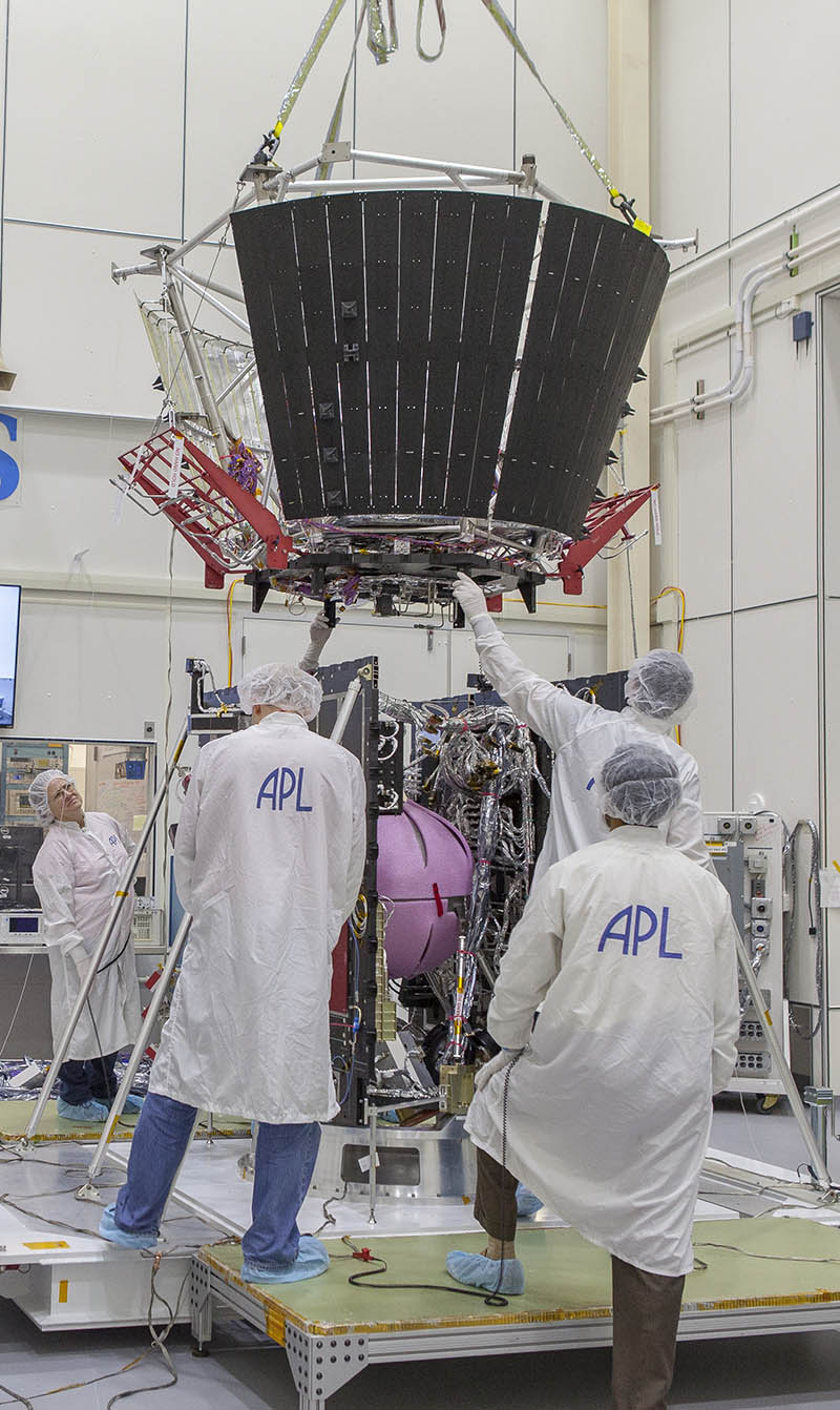 From left, Cheryl Starkey, Justin Hahn, Felipe Ruiz, Randy Persaud and Jim Beatty (obstructed by spacecraft) position the deck holding the structure assembly and several other critical thermal-protection components atop NASA’s Solar Probe Plus spacecraft body on April 5, 2017, in the cleanroom at the Johns Hopkins University Applied Physics Laboratory in Laurel, Maryland. 
