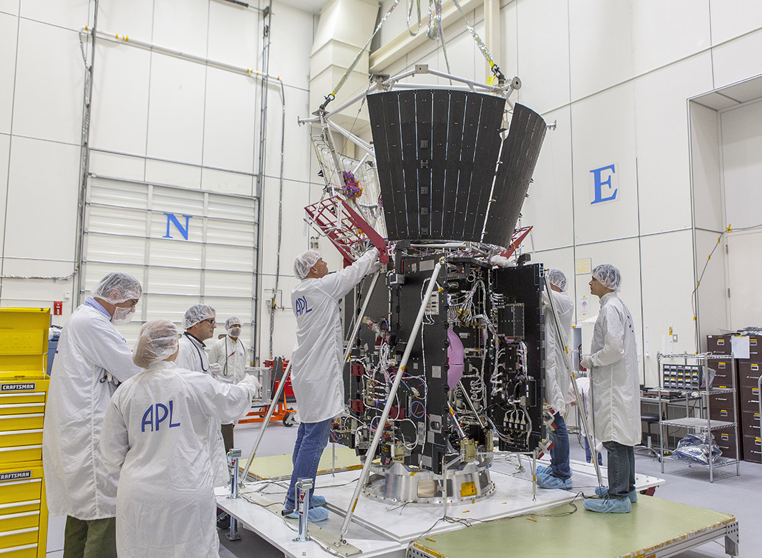 Parker Solar Prob mission integration and test team members secure the deck holding the structure assembly and several other critical thermal-protection components atop NASA’s Solar Probe Plus spacecraft body on April 5, 2017, in the cleanroom at the Johns Hopkins Applied Physics Laboratory in Laurel, Maryland. 