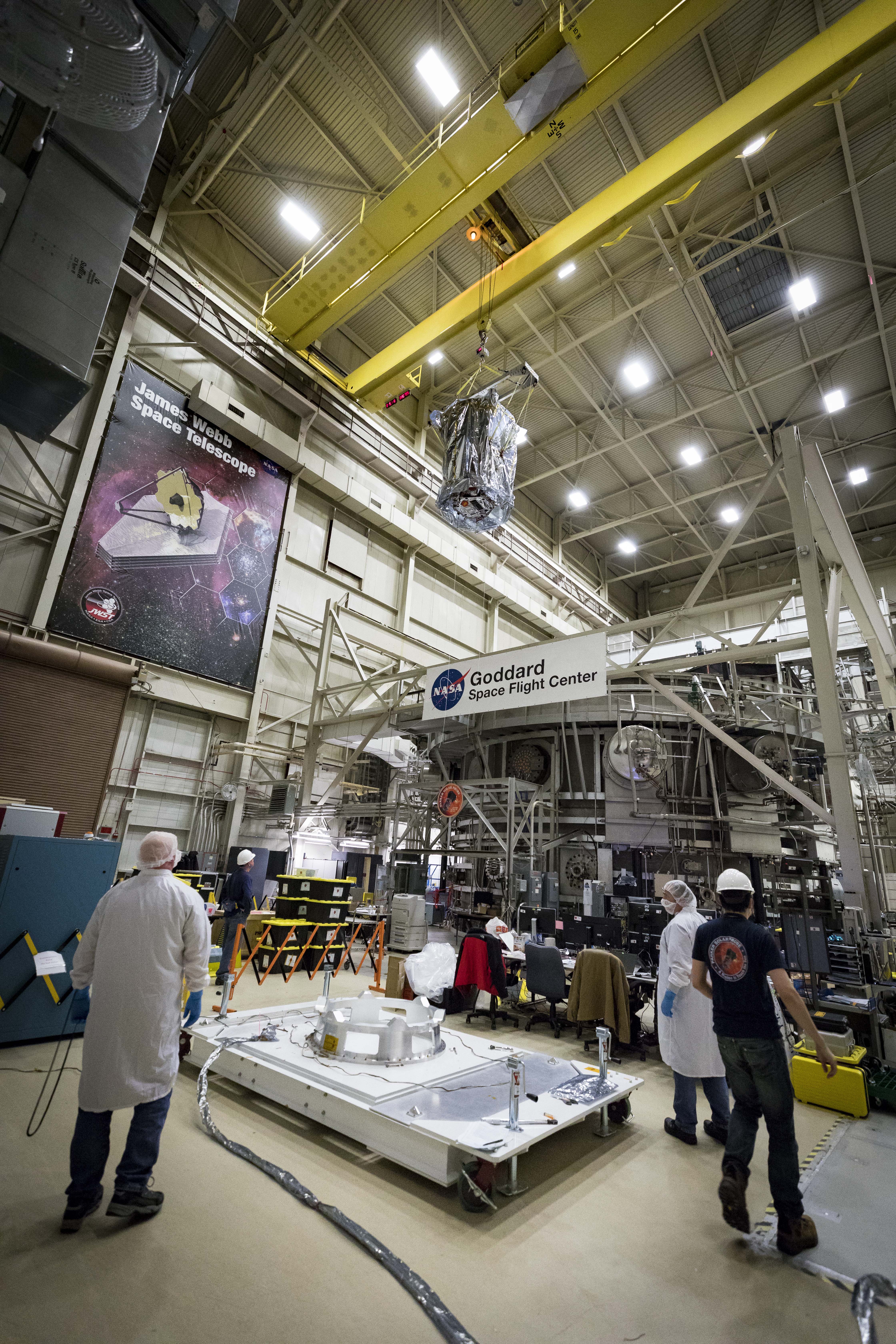 Members of the Parker Solar Probe team from the Johns Hopkins Applied Physics Lab in Laurel, Maryland, monitor the progress of the spacecraft as it is lifted from the Space Environment Simulator at NASA’s Goddard Space Flight Center in Greenbelt, Maryland, and lowered to the custom platform visible in the foreground. The spacecraft has spent eight weeks undergoing space environment testing in the thermal vacuum chamber before being lifted out on March 24, 2018. 