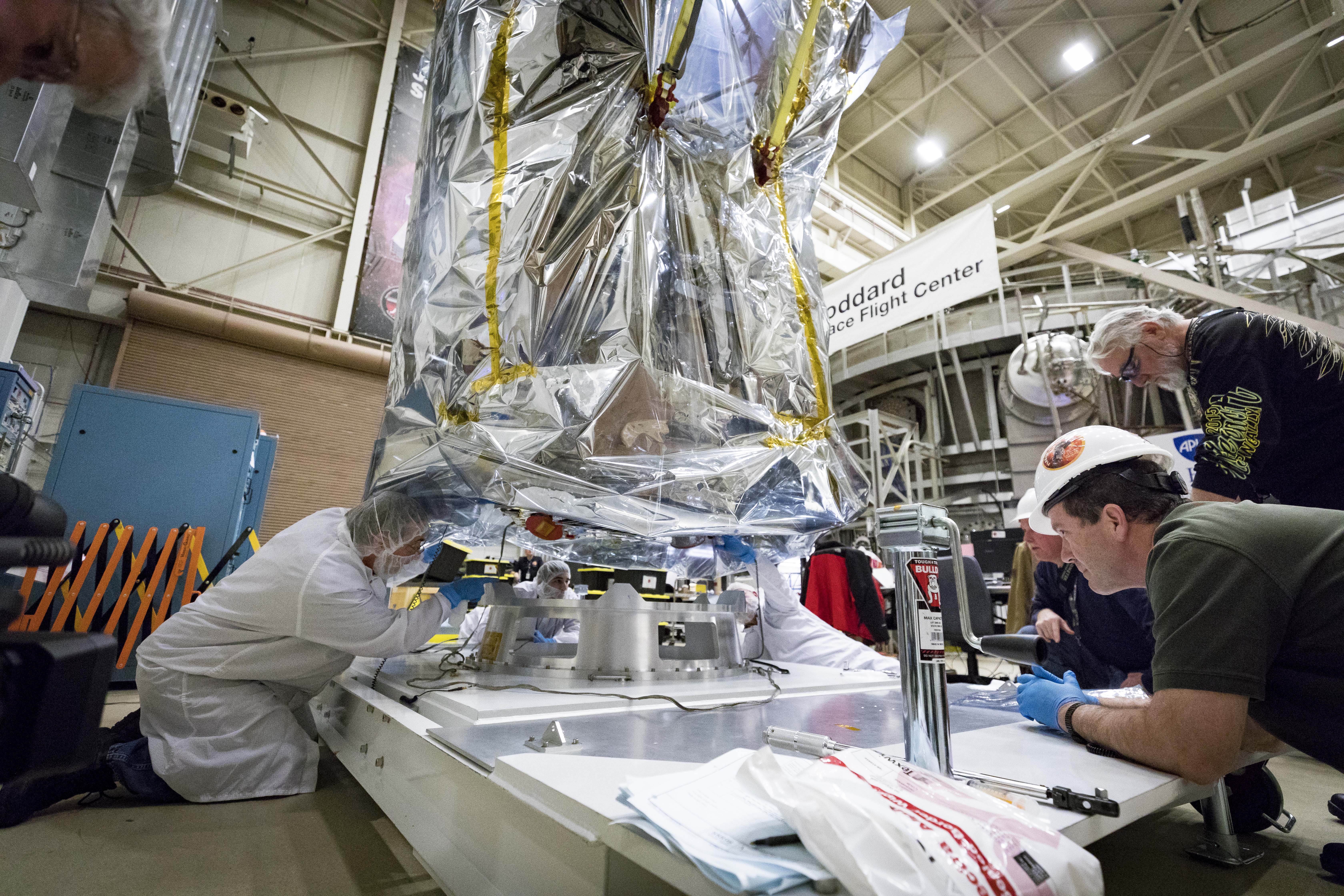 Parker Solar Probe team members connect the spacecraft to a specially built platform after removing the probe from the Space Environment Simulator at NASA’s Goddard Space Flight Center in Greenbelt, Maryland, on March 24, 2018. The probe will undergo about seven more days of testing outside the chamber, then travel to Florida for a scheduled launch on July 31, 2018, from NASA’s Kennedy Space Center in Cape Canaveral.