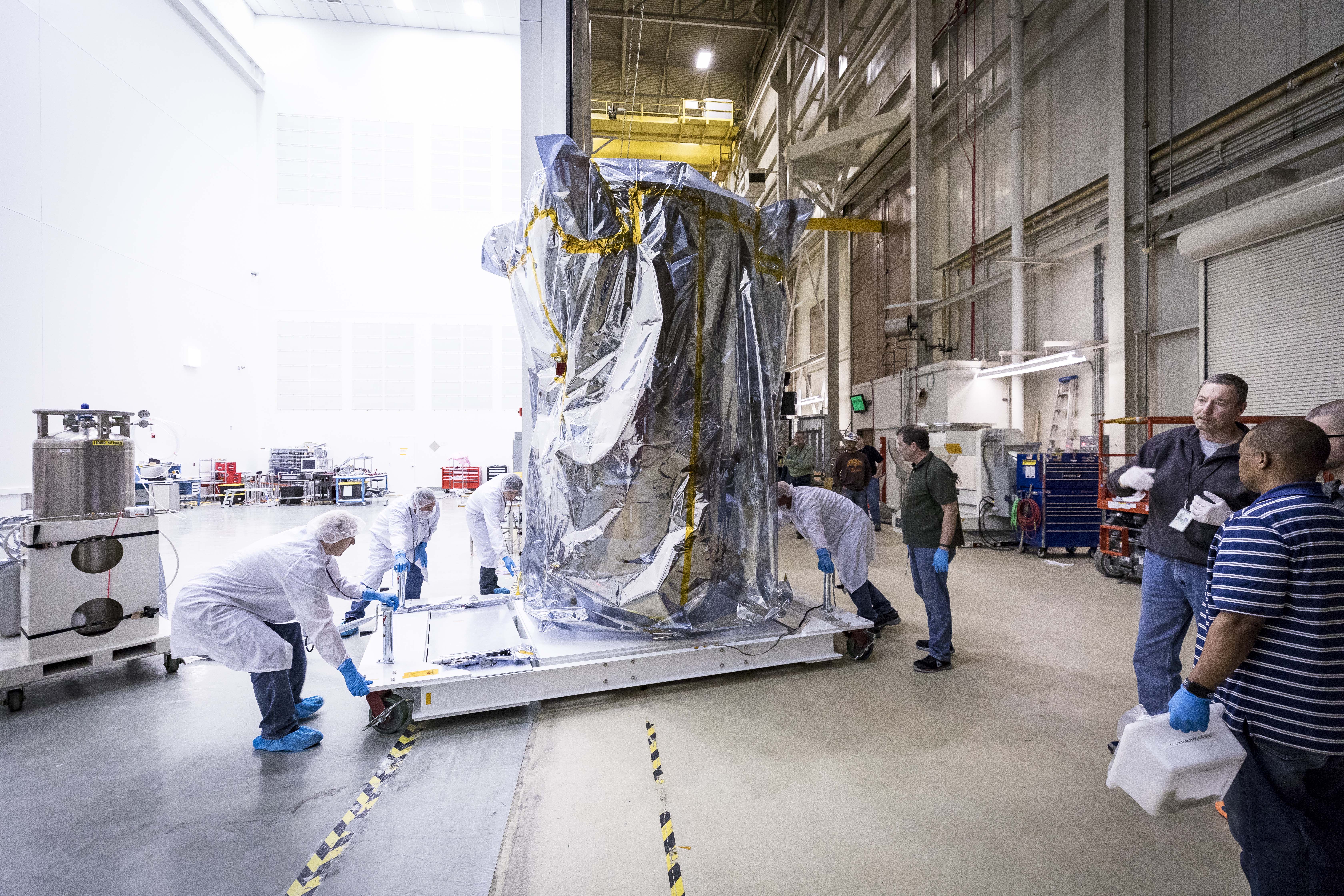 NASA’s Parker Solar Probe is wheeled into a clean room at NASA’s Goddard Space Flight Center in Greenbelt, Maryland, on March 24, 2018, after successfully completing space environment testing to verify the spacecraft is ready for operations in space. The probe will undergo about seven more days of testing outside the chamber, then travel to Florida for a scheduled launch on July 31, 2018, from NASA’s Kennedy Space Center in Cape Canaveral.