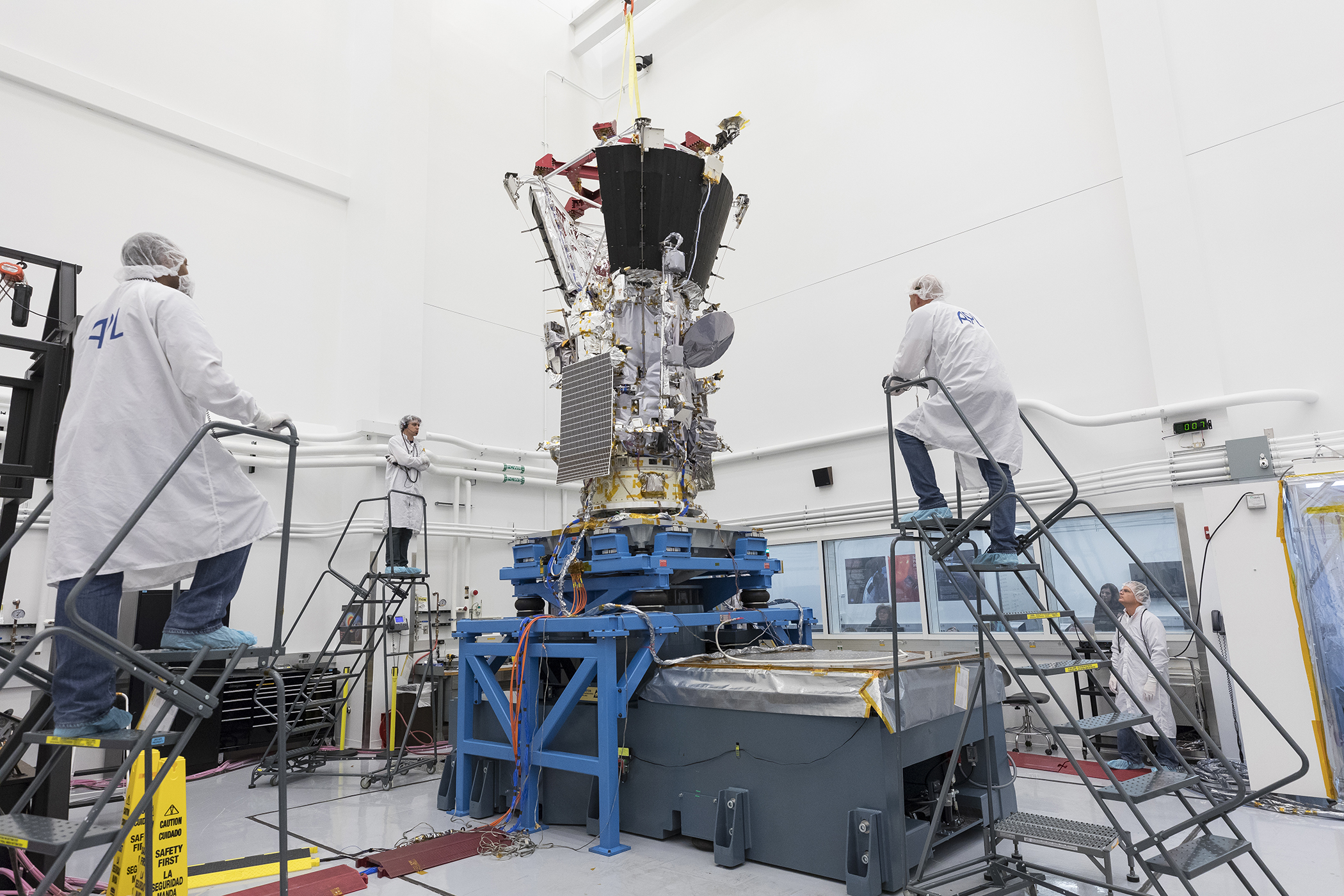 Engineers and technicians at the Johns Hopkins University Applied Physics Lab closely monitor vibration testing of NASA's Parker Solar Probe. The spacecraft is attached to a shaker table, which simulates the intense physical forces of launch and powered flight. 